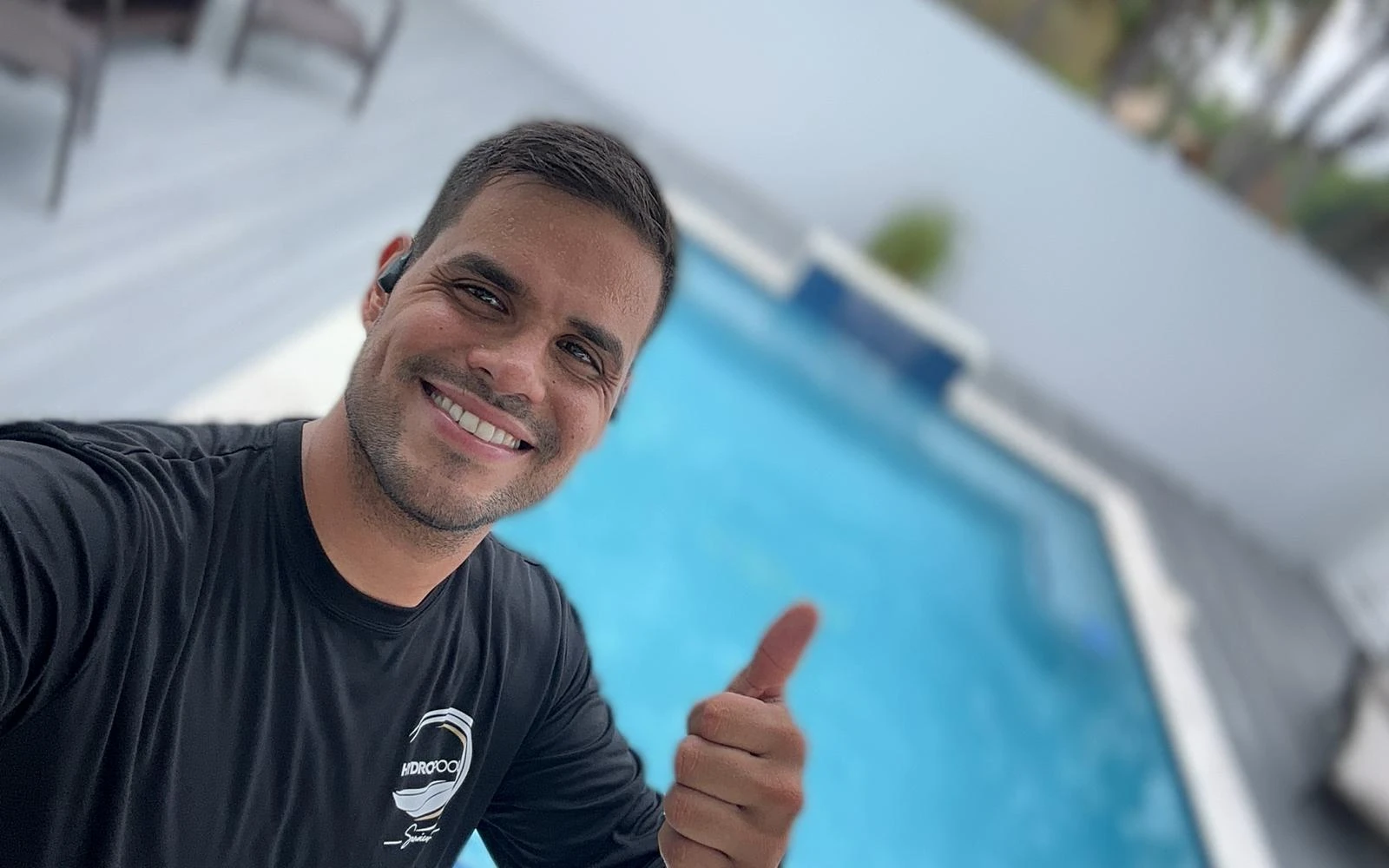 Andres from Hydropool Services smiling beside a swimming pool