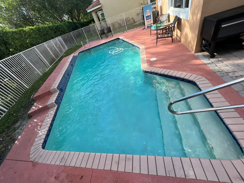 Same pool after service with blue water and visible entry steps