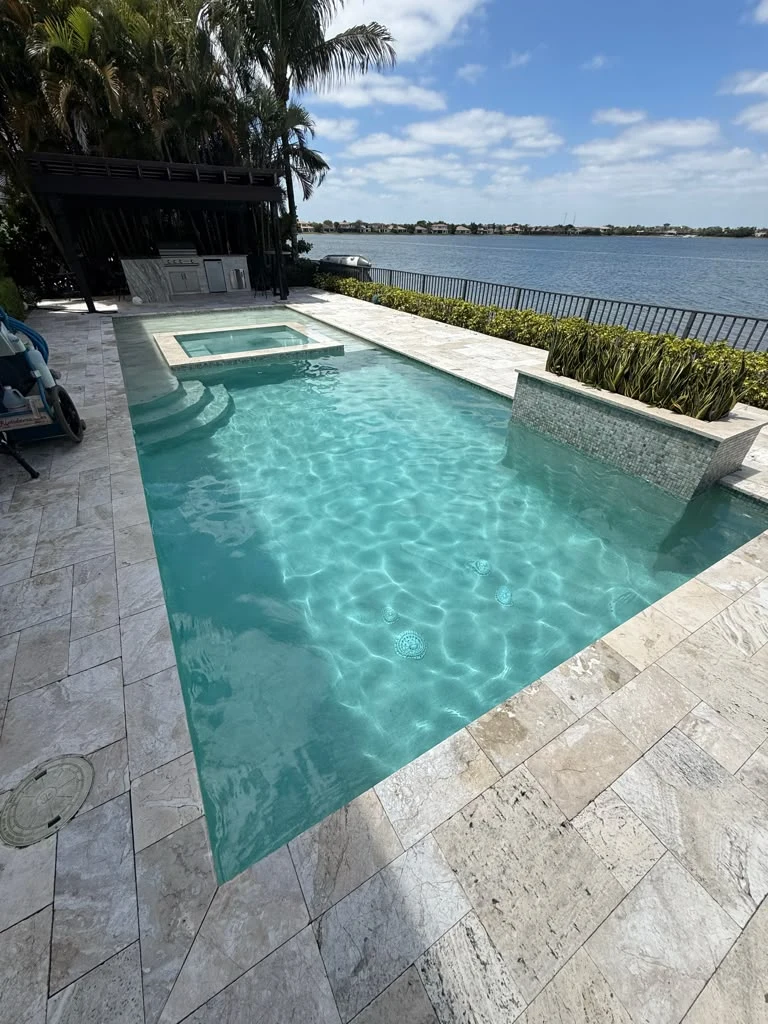 Maintained swimming pool with clear water beside a lake
